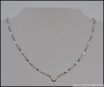 An 18ct white gold and blue diamond ladies necklace.