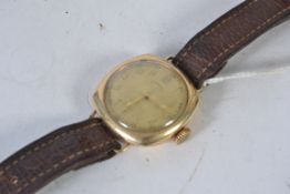 A vintage mens Ingersoll Rolled gold watch with brown leather strap.
