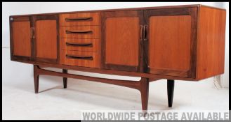 A good retro 1970's long and low G plan Fresco teak sideboard enclosed by moulded panelled door