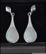 A pair of silver CZ and opal earrings