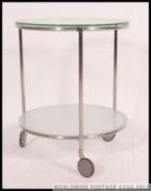 A vintage mid century chrome and glass two tier occasional table on castors,
