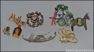 A collection of 7 vintage brooch pins to include white metal yellow metal and Mexican silver.