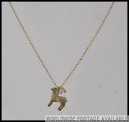 A 9ct gold hallmarked pendant necklace strung with a gazel pendant with illusion set diamond,