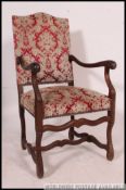 A 19th century walnut upholstered Osso Bucco French provincial fauteuil armchair having shaped legs