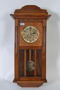 A vintage mid 20th century golden oak cased drop dial wall clock,