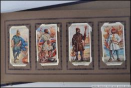 A vintage cigarette card album ' Cigarette Picture Album ' containing several cards - Players