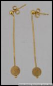 A pair of 375 9ct gold drop earrings with planished ball finials.
