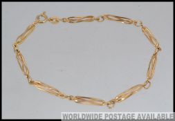 A 9ct / 375 marked contemporary bar linked ladies bracelet with clasp.