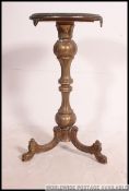 A 19th century gilt brass and rouge marble tripod table.