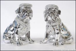 A pair of ceramic chromed bookends in the form of Pug's / Bull dogs, both in a seated position.