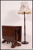 A 1930's drop leaf dining table together with a mahogany standard lamp with shade on circular