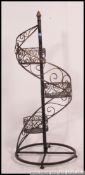 A 20th century contemporary wire work florists plant stand having multiple tiers on twist stem