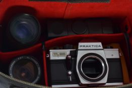 A vintage cased 35mm Praktika camera and lenses, flash head and other accessories.