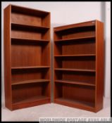 2 retro teak wood upright bookcase cabinets having central shelves to each ,
