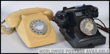 A vintage mid 20th century bakelite ring dial telephone complete with it's cheese tray,