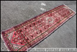 A large early 20th century handwoven Persian / Islamic rug having blue zig zag borders with