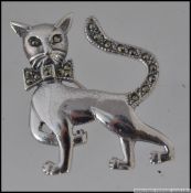 A silver and marcasite cat brooch