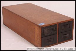 An early to mid 20th century industrial oak table top index filing cabinet,