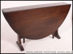 A 20th century large Ercol drop leaf dining table.