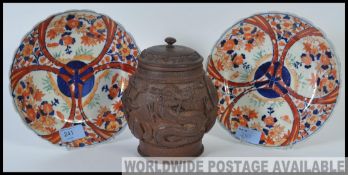 A near pair of Japanese 19th / 20th century Imari plates along with a carved wooden Chinese tea