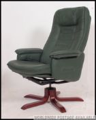 A green leather reclining swivel captains chair by quality makers 'Daneway' on a rosewood star base.