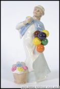 A Royal Doulton Reflections Figurine entitled Covent Garden HN2857 being marked to the base H27cm