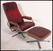 A retro 1980's ox - blood leather and chromed tubular metal reclining swivel armchair and