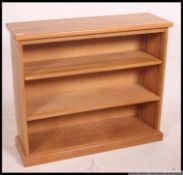 A good quality chunky oak veneer contemporary open window bookcase cabinet raised on plinth base