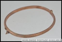 A vintage hallmarked 9ct gold bangle bracelet with clip clasp hallmarked for Birmingham Joseph