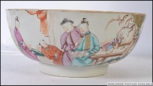 A 19th century Chinese famille rose large bowl raised on inset circular step plinth,