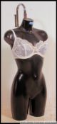A retro 20th century half mannequin shop torso / tailers dummy of black plastic / resin form.
