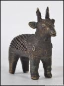 A Chinese bronze cricket cage in the form of a deer having pierced body with decorative head etc