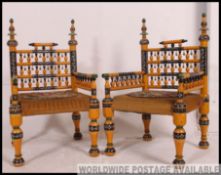 A stunning pair of Indian handpainted yellow opium / hall chairs raised on turned legs with