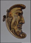 A brass cased vesta in the form of a half shaped moon