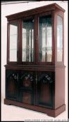 A Regency mahogany sideboard / bookcase dresser comprising a series of cupboards ,