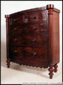 A Victorian bow front Scottish mahogany chest of drawers being raised on turned legs with 2 short