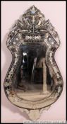 A fabulous 20th century Venetian mirror of shaped form being acid etched decorated with crested top