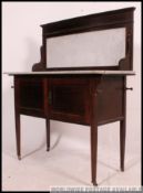An Edwardian mahogany inlaid and marble top washstand cabinet raised on square tapered legs with