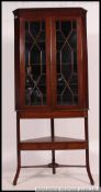 A 19th century Georgian / Regency mahogany large corner cabinet on stand.