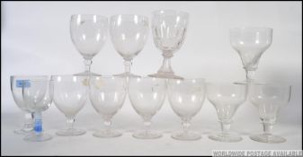 A collection of glasses to include a set of 6 rummers together with others that include cut glass