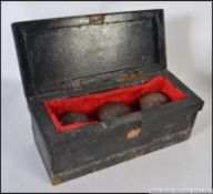 A set of 18th century treen bowling balls complete in a velvet lined pine box.
