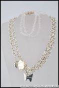Two silver white metal necklaces both stamped Franz Louissica London,