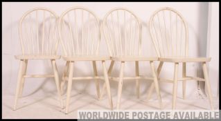 A set of 4 painted white country pine stick back kitchen chairs in the manner of Habitat.