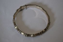 A designer hallmarked 925 silver bone link bracelet bangle with hidden clip clasp and safety chain