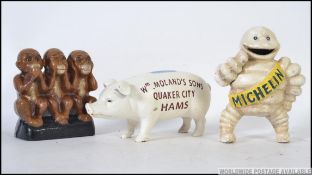 A collection of 3x reproduction case iron painted advertising money boxes - to include a Michelin
