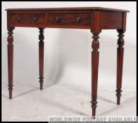 A Victorian mahogany writing table of good quality being raised on turned legs with frieze drawers