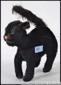 Antique wood wool stuffed black kitten, with tail and squeaker.