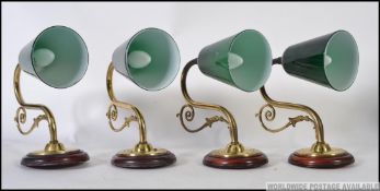 Set of four 20th Century brass wall lights, having green glass pendant shades,