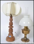 A retro oak mid century table lamp together with a brass and milk glass oil lamp. 23 inch.