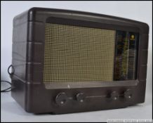 A vintage early 20th century Pye bakelite valve radio with decorative facia